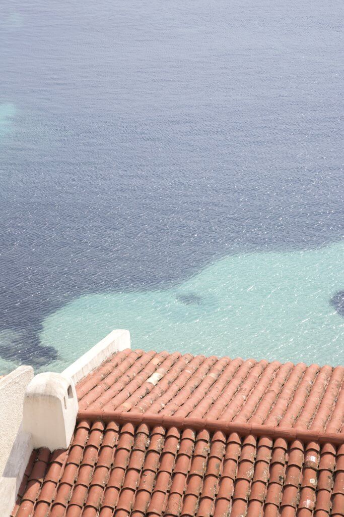 Tile roof and the Mediterranean Sea on the way from Villefranche to Beaulieu-sur-Mer, France, by Cattie Coyle Photography. © 2019, all rights reserved.