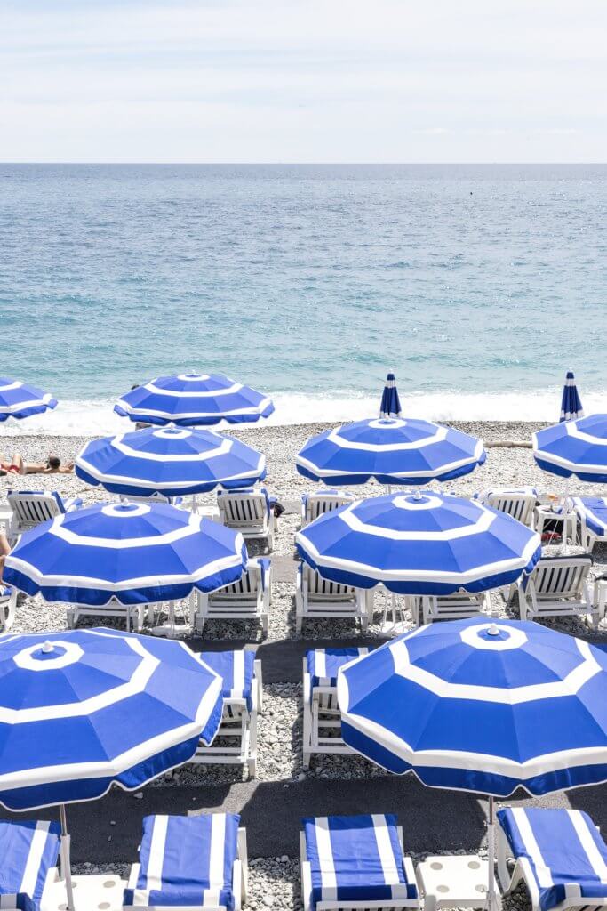 Parasols on the beach in Nice, France by Cattie Coyle Photography. © 2019, all rights reserved.