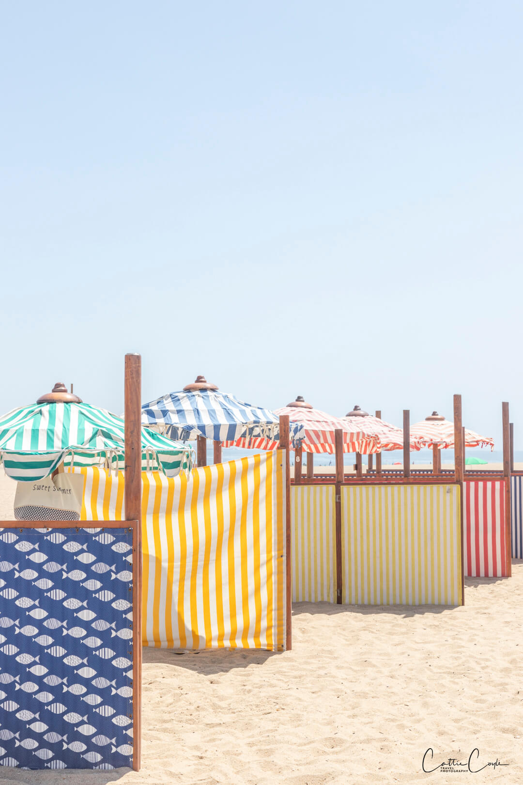 Beach umbrellas at Praia da Aguda, Portugal by Cattie Coyle Photography. © 2024, all rights reserved.