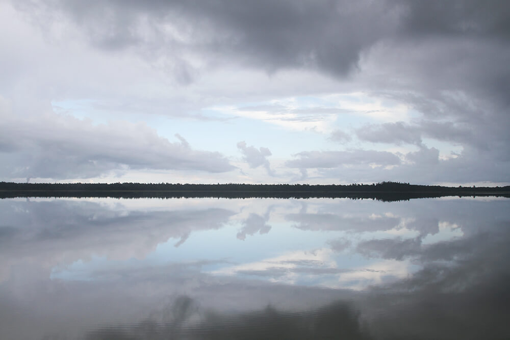 Storm clouds and calm water at Tingstäde Träsk, Gotland, Sweden, by Cattie Coyle Photography. © 2017, all rights reserved.